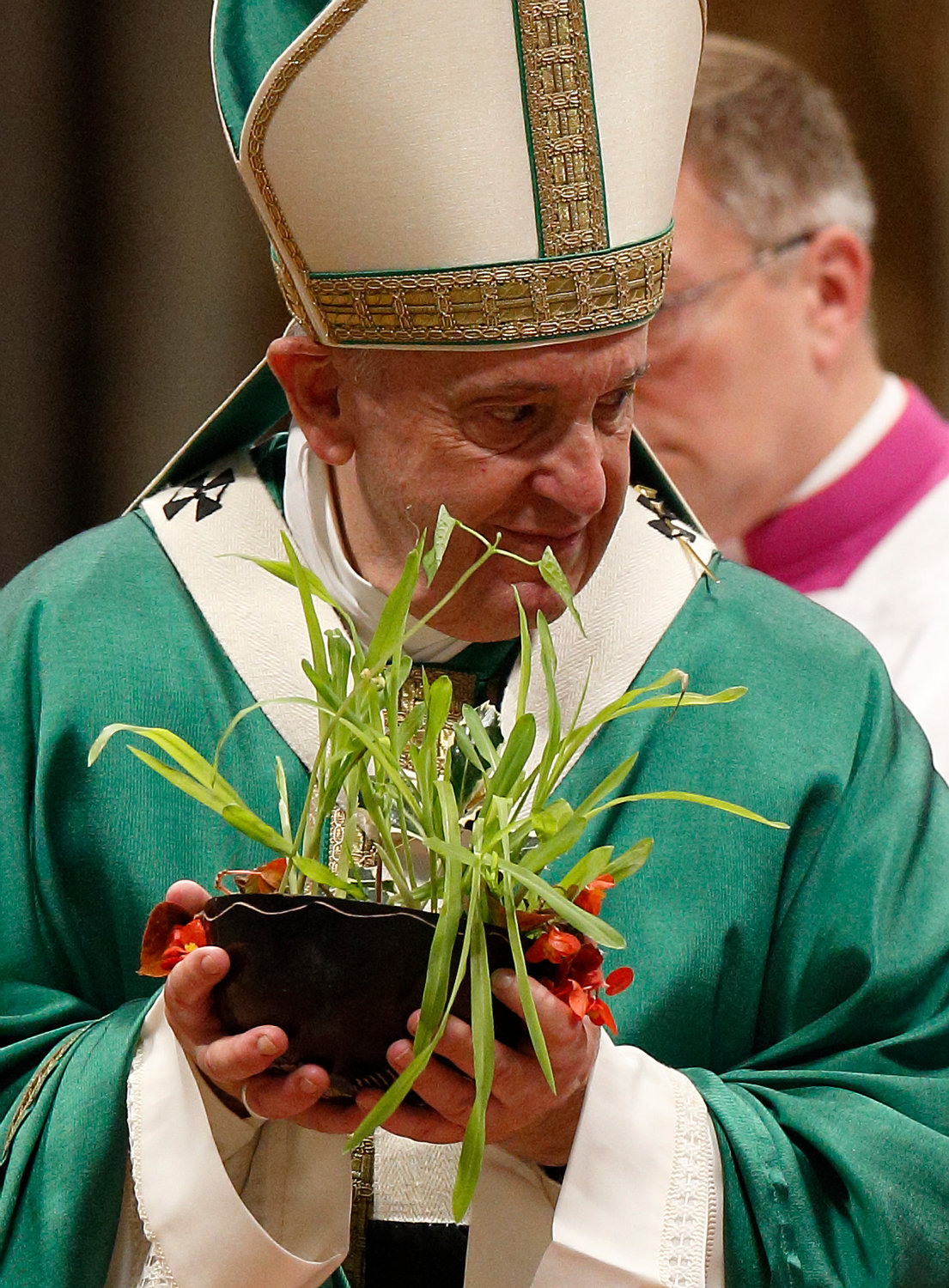 Pope Francis holds a plant presented during the offertory during the concluding Mass of the Synod of Bishops for the Amazon at the Vatican in this Oct. 27, 2019, file photo. The Vatican on Feb. 12 released the Pope’s apostolic exhortation, “Querida Amazonia” (Beloved Amazonia), which offers his conclusions from the synod.